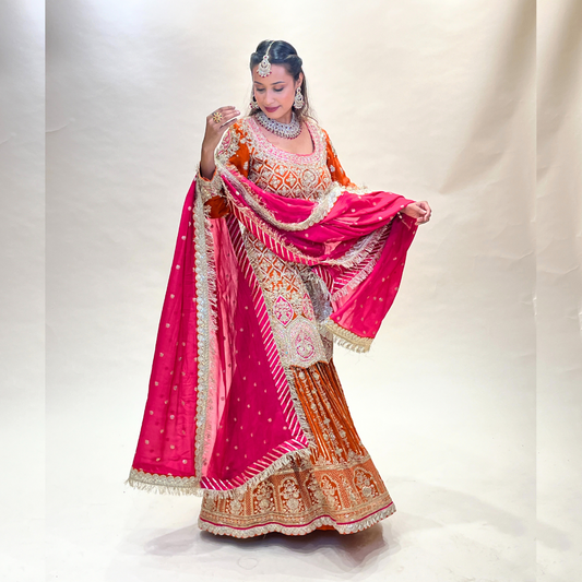 Orange colored sharara set with heavy handwork in georgette